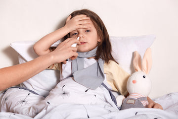 A sick girl with her stuffed rabbit, possibly allergic to her pet rabbit