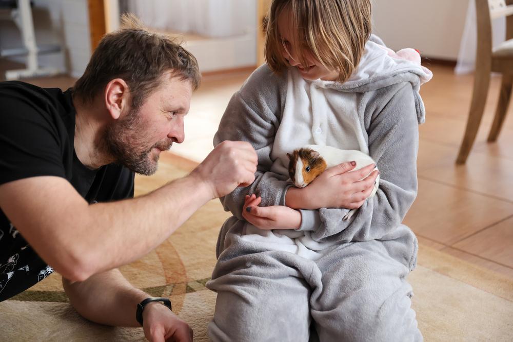 Dad and child with guinea pig