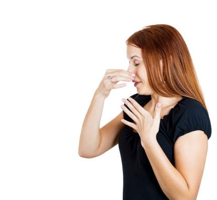 Woman holding nose, rabbit litter box.