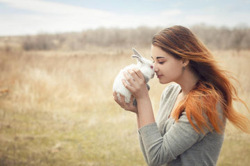 Woman holding a white rabbit